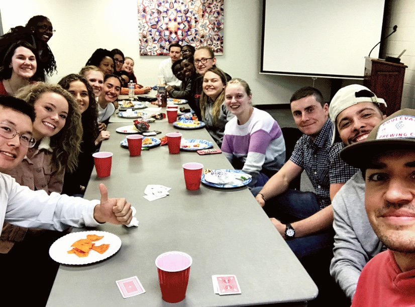 Group of college students gathered around a table