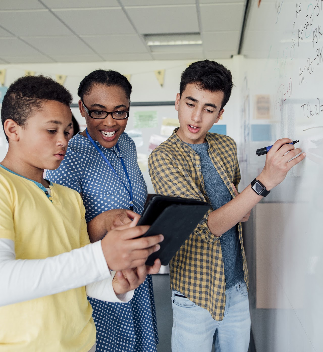 Students and teacher discussing the mathematics problem.